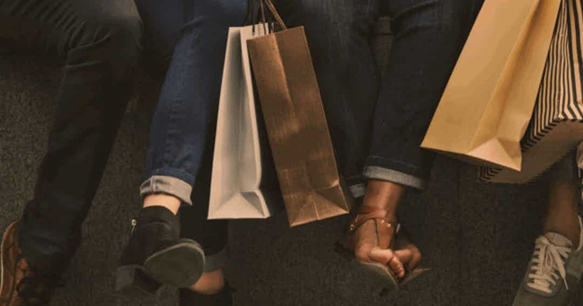 People sitting down with shopping bags