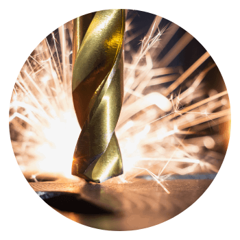 drill bit with sparks in background - representing manufacturing software solutions