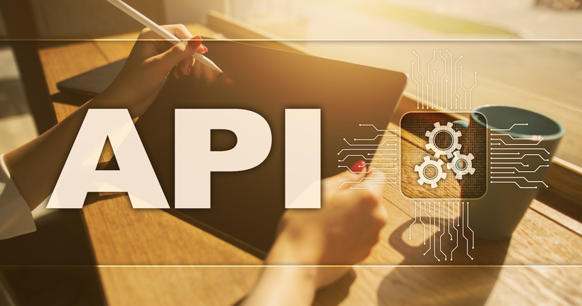 Person on tablet in coffee shop with letters API over image