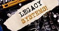Handwriting Announcement text showing Legacy Systems. Business concept for Upgrade SOA Application Written on sticky note, computer main board