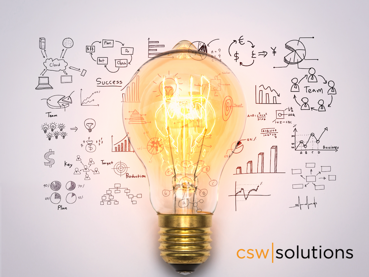 Light bulb in front of backdrop of concept drawings