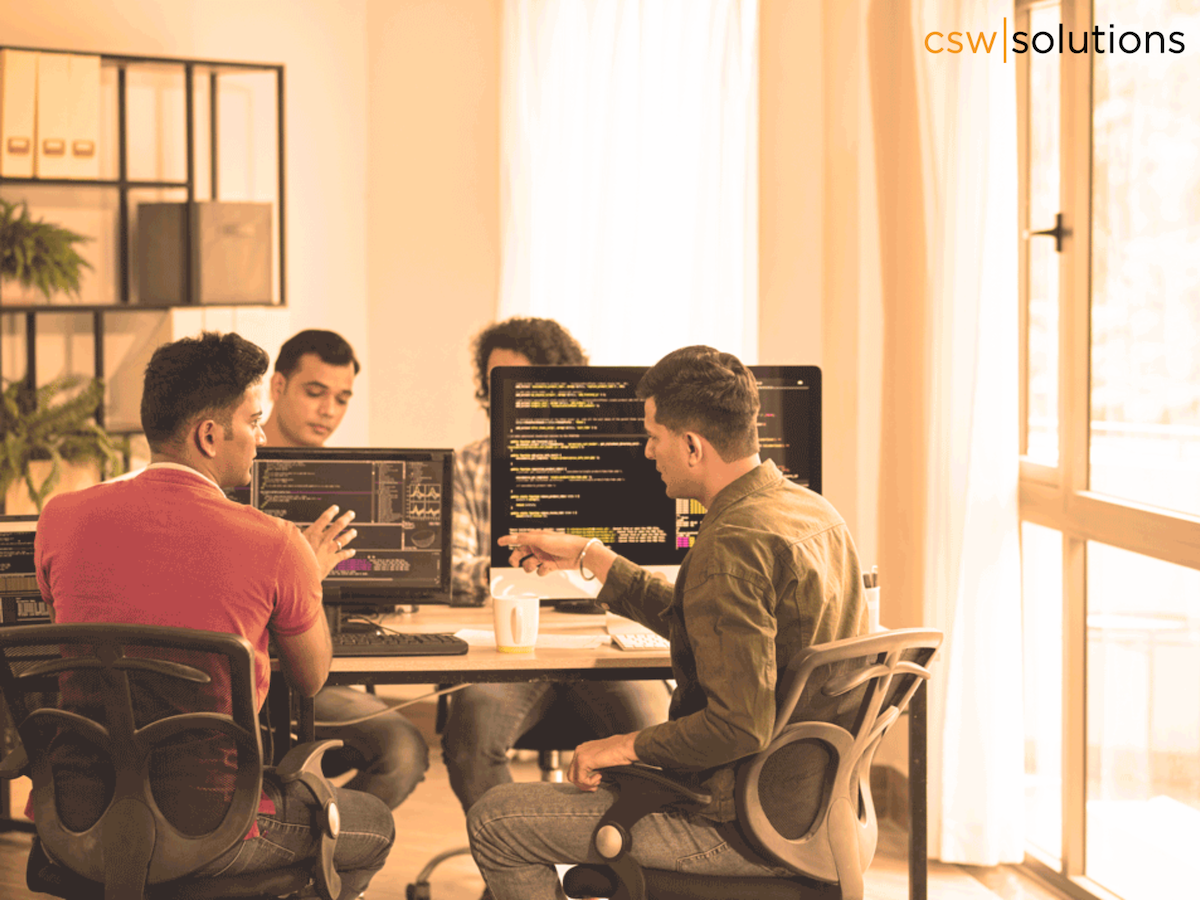 Team of multicultural software developers working on maintaining zero downtime