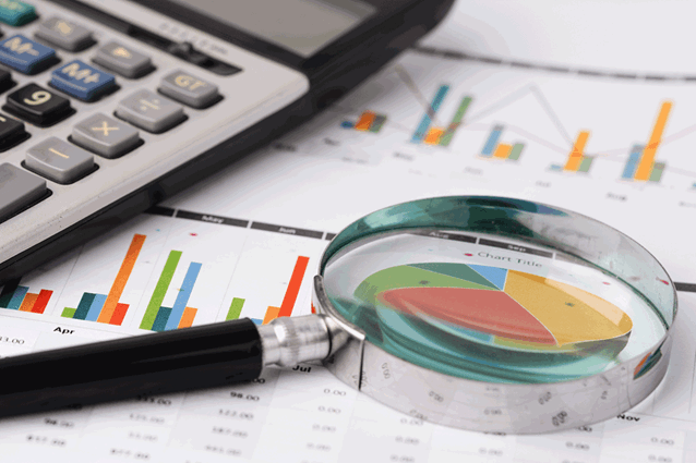 Magnifying glass over printed data analytics